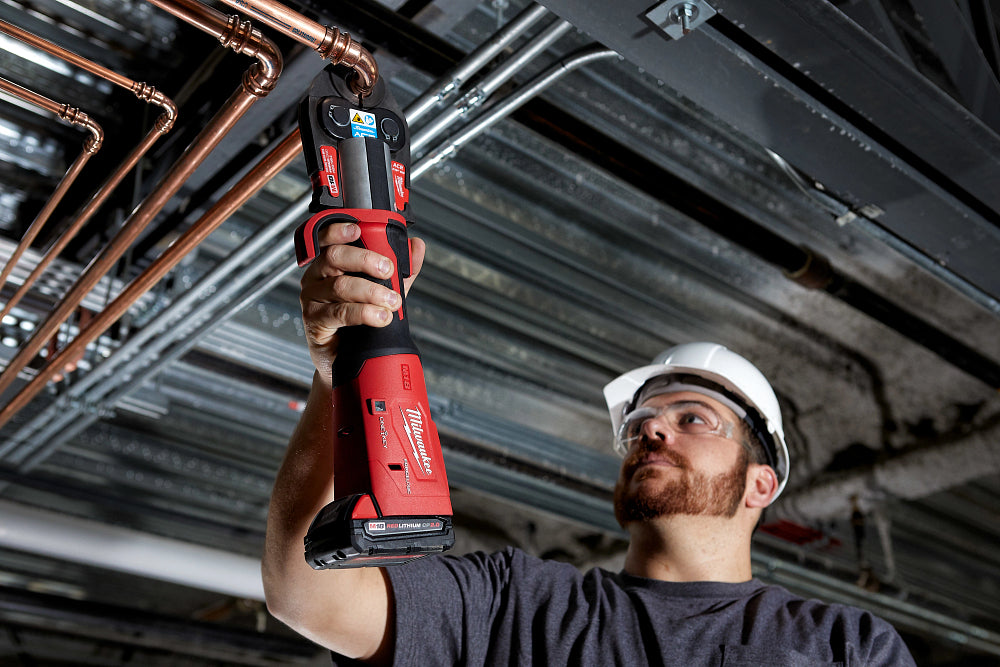 A man in a hard hat using M18™ FORCE LOGIC™ Press Tool Kit w/ One-Key™ with 1/4"-7/8" Streamline ACR™ Jaws