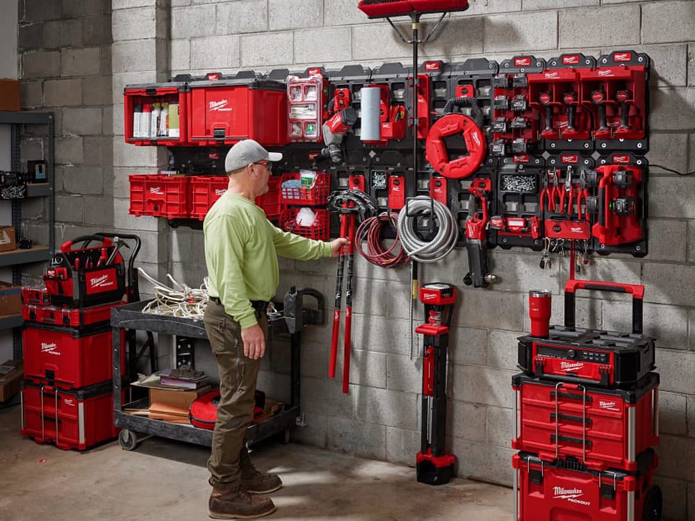 Man in front a suite of Milwaukee PACKOUT storage products